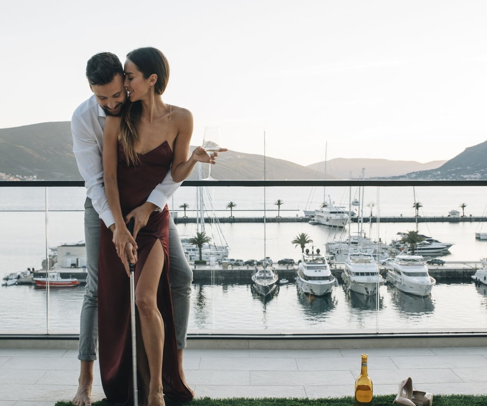 Couple playing golf on balcony