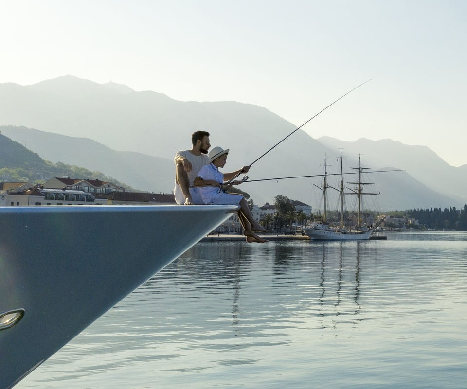 Father and son fishing on yacht Montenegro