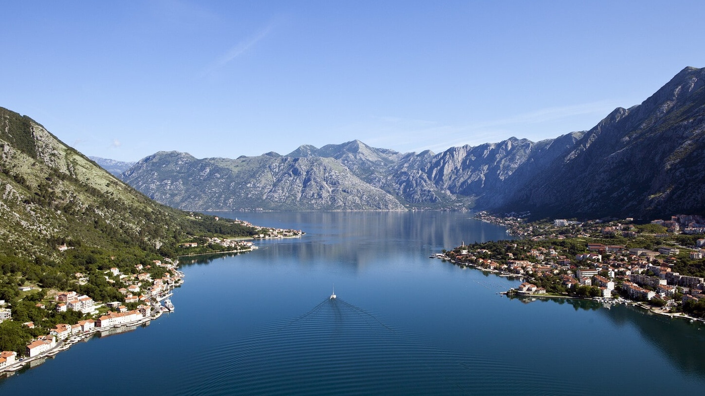 Boat in the sea surrounded by mountains