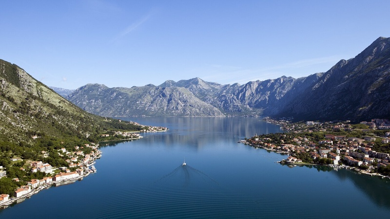 Boat in the sea surrounded by mountains