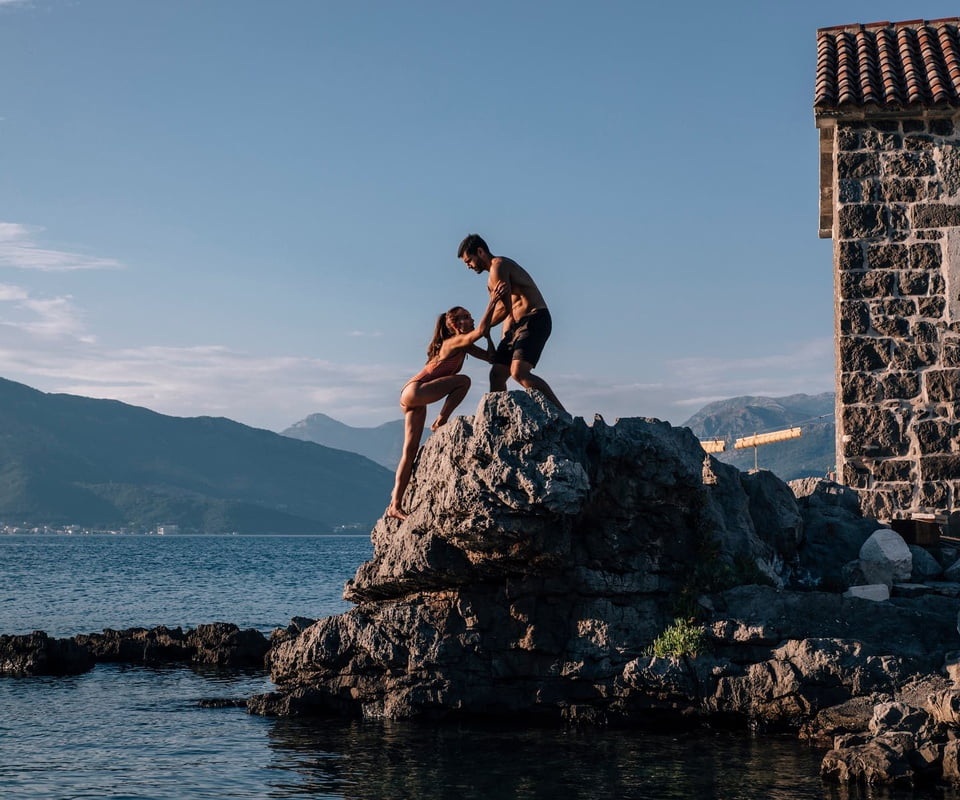 Man and woman climbing rock