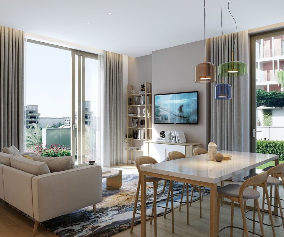 Modern apartment interior with a cosy living room that opens to a balcony with greenery.