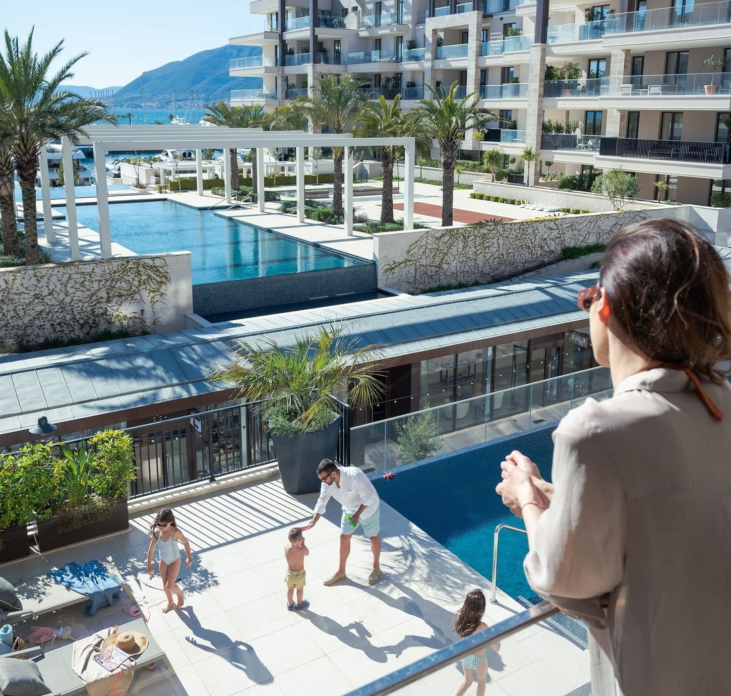 Family by swimming pool - Porto Montenegro Real Estate