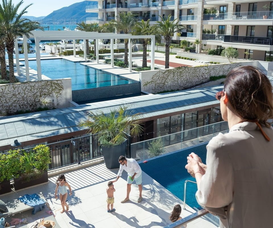 Family by swimming pool - Porto Montenegro Real Estate