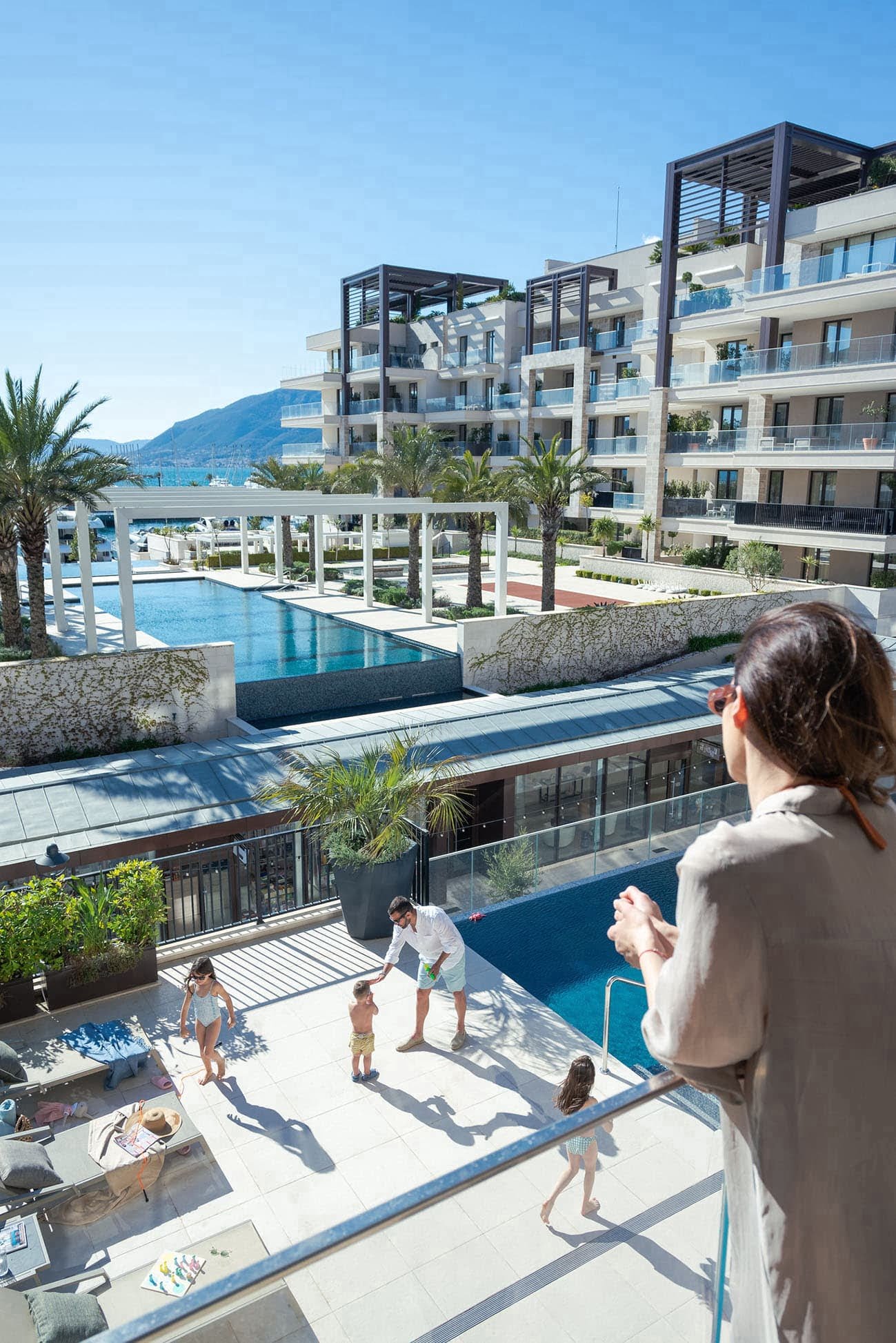 Family by swimming pool in Porto Montenegro residence