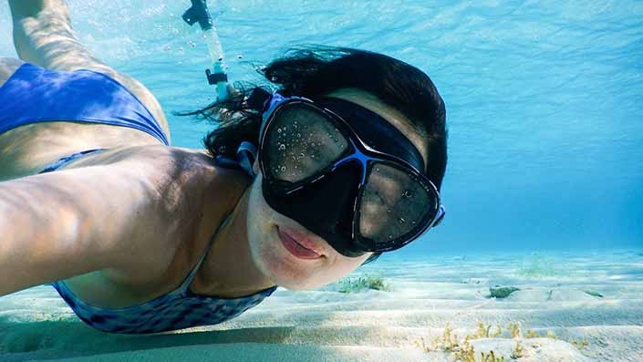 A woman snorkeling.