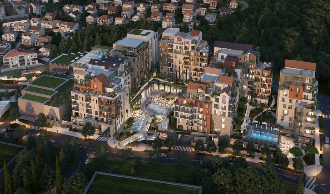 Aerial view of a luxury residential complex Boka Place, nestled within a vibrant, green landscape. The modern architecture blends seamlessly with traditional design elements, featuring rooftop terraces, lush courtyards, and a central plaza.