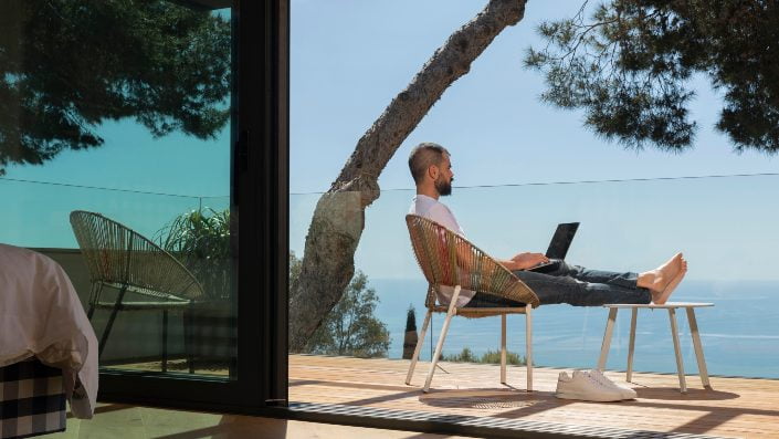 Man sitting on a chair with sea view in front of him