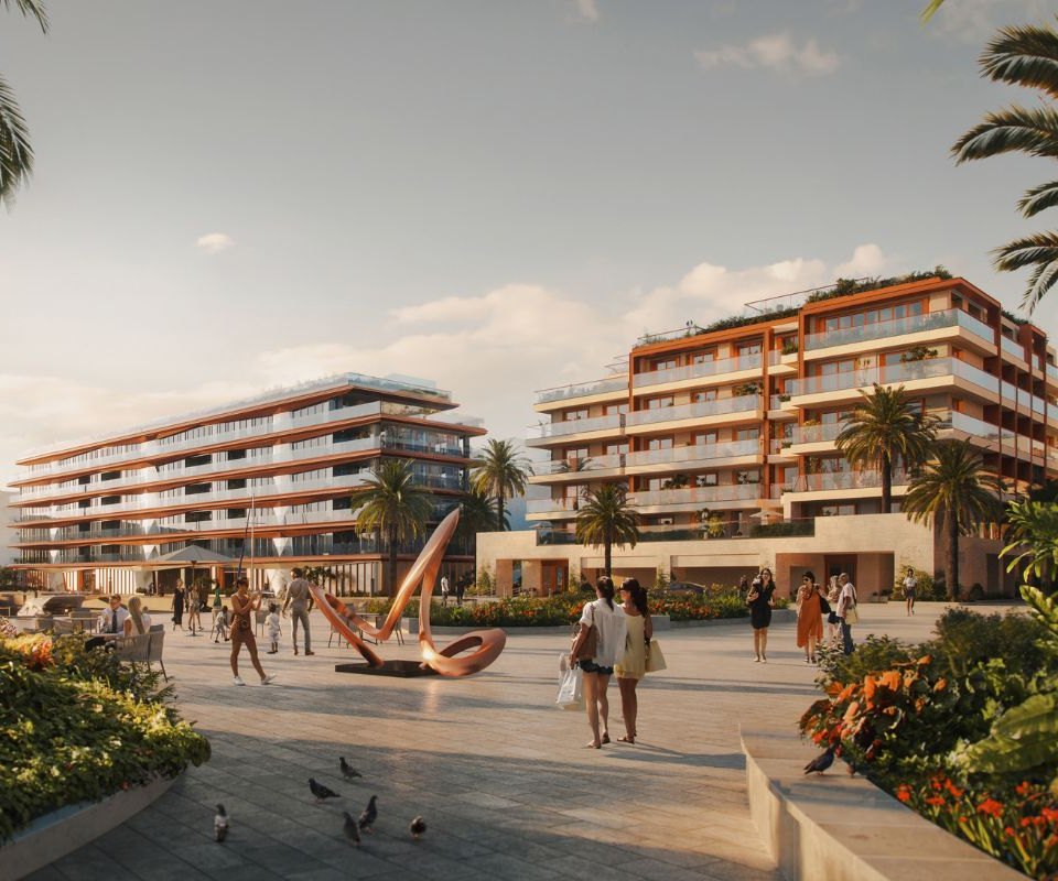 Sunny courtyard scene at the IVO Residences in Porto Montenegro, featuring a modern apartment complex with terraced balconies surrounded by tall palm trees and vibrant greenery.