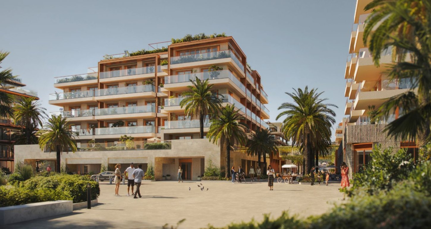 Modern bustling hotel complex IVO Residences in Porto Montenegro, featuring multi-level architecture, lush palm trees, and vibrant pedestrian activity on a sunny day.