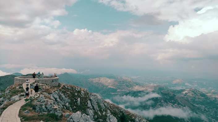 Majestic view of Lovćen Mountain, featuring its impressive heights, lush greenery, and panoramic views stretching across the landscape.