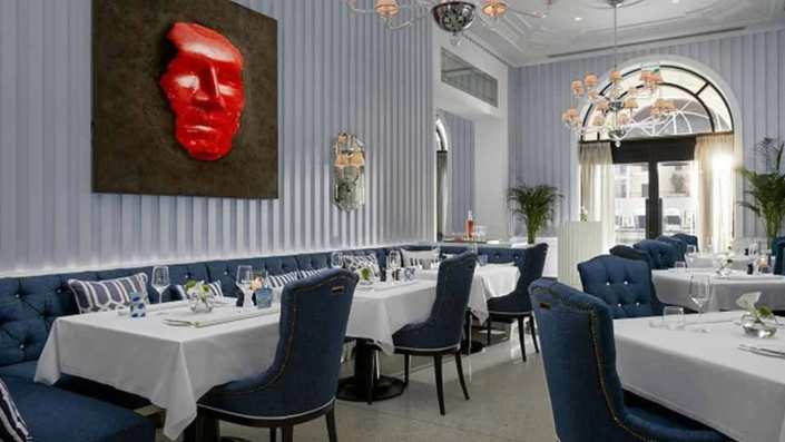 Elegant interior of Murano Restaurant at Regent Porto Montenegro featuring sophisticated decor, stylish furniture, and a warm, inviting atmosphere.
