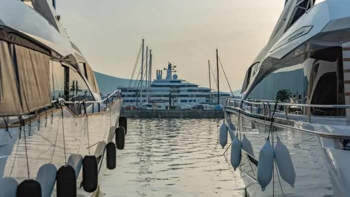 A superyacht docked at Porto Montenegro, showcasing luxury living in the marina with stunning views and a sophisticated ambiance.