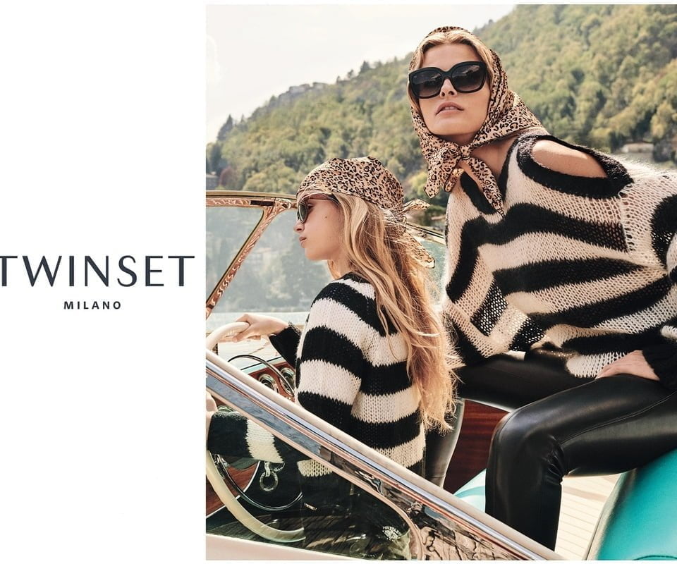 Lady on yacht in Twin-set/pinko poncho
