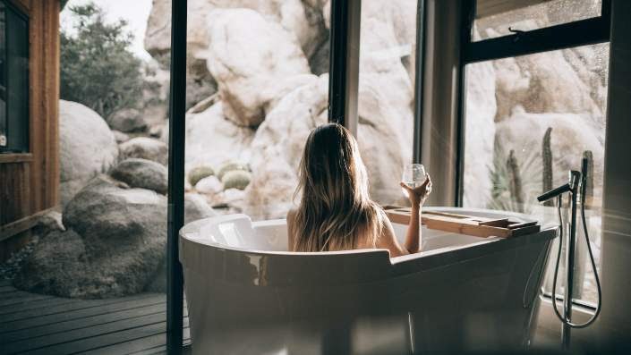 Women in bathtub with glass