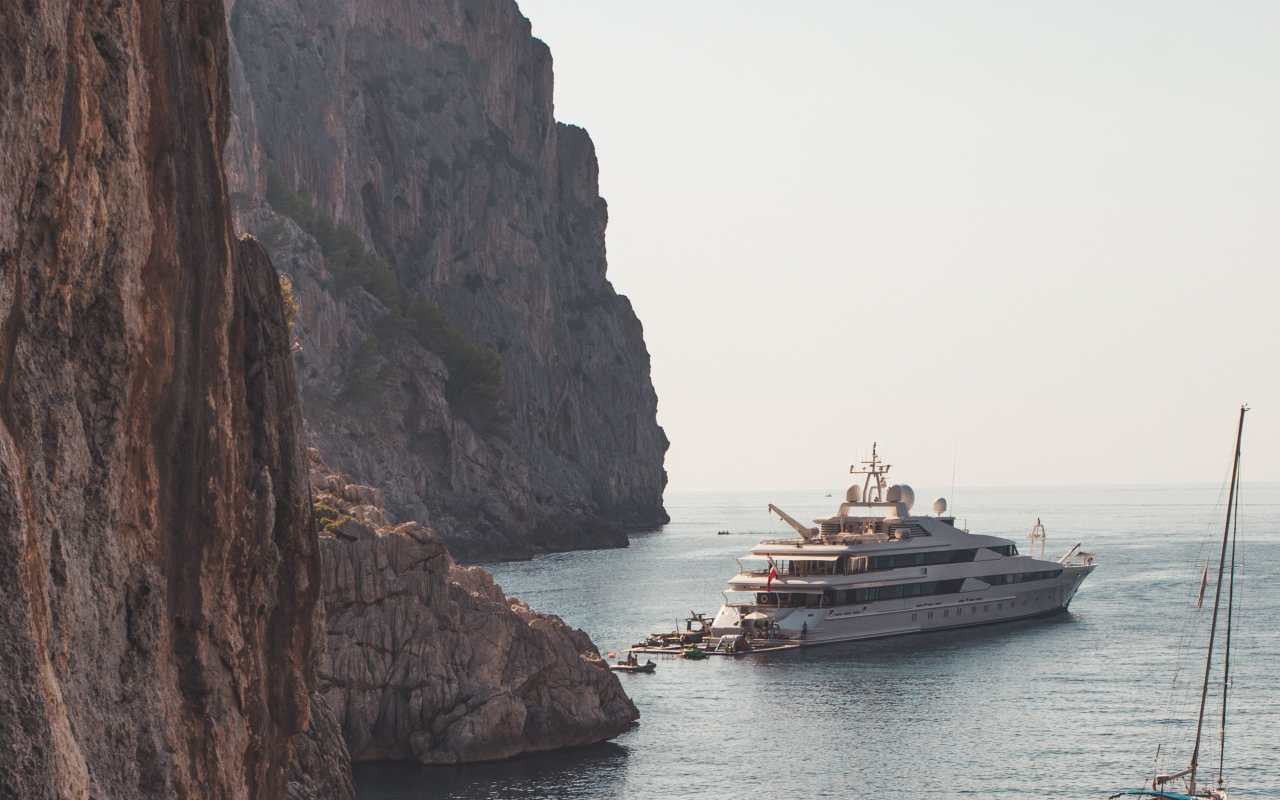 Yacht near a rock