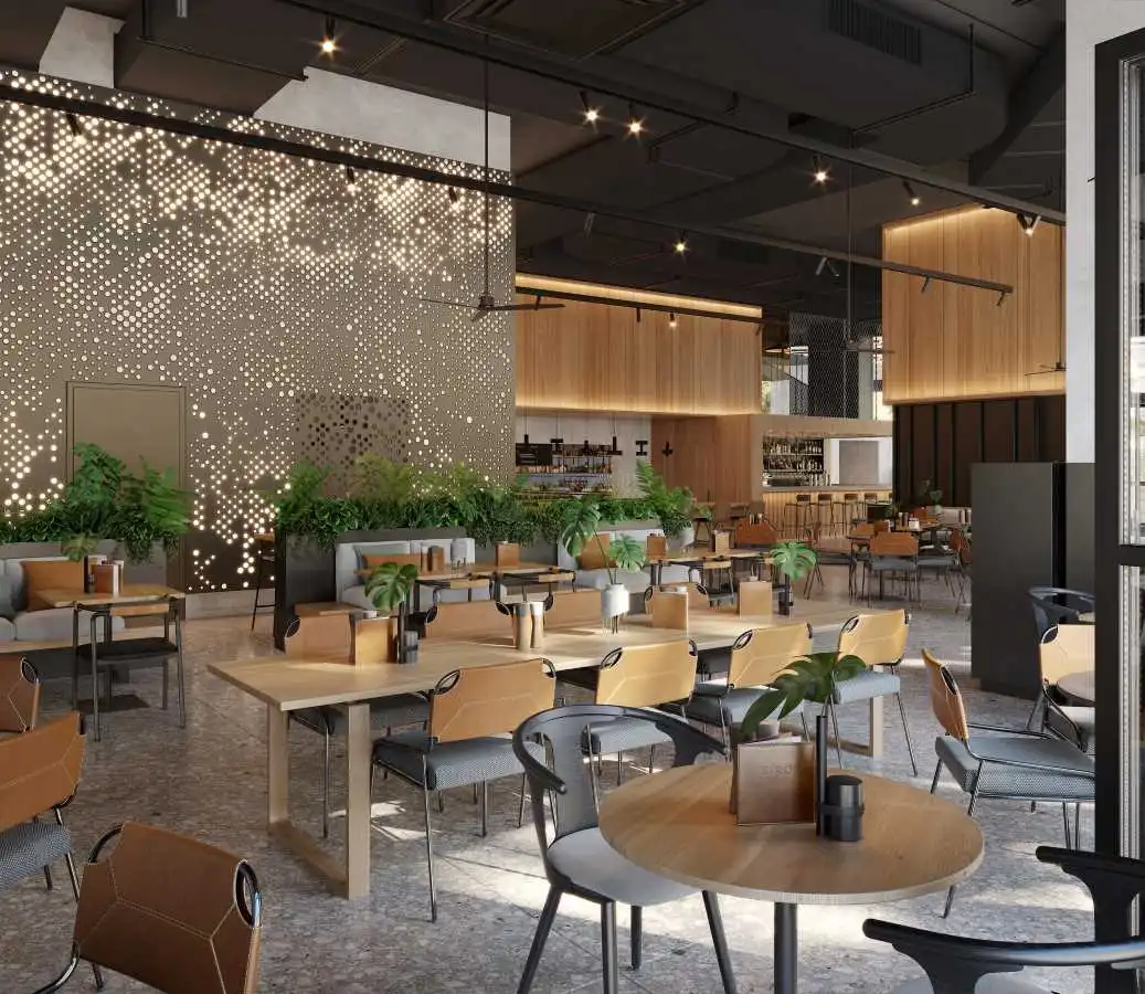 Modern cafe with sleek wooden accents and natural tones, featuring indoor greenery and ambient lighting. The space includes round tables, comfortable seating, and a bar area in the background, creating a warm and inviting atmosphere.