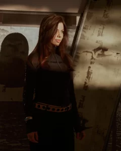 Portrait of Darja Bajagic standing in partial shadow wearing a black top and studded belt.