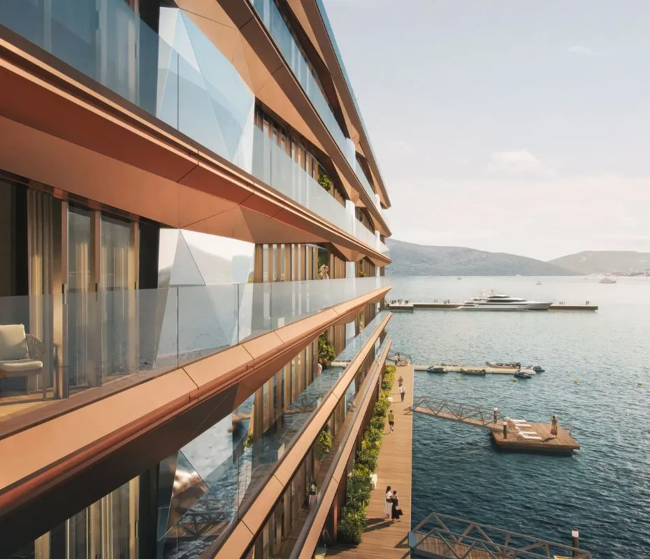 Close-up view of the modern terraced architecture of a waterfront AERIS residence in Porto Montenegro, highlighting spacious balconies with elegant outdoor furniture overlooking the scenic Adriatic Sea.